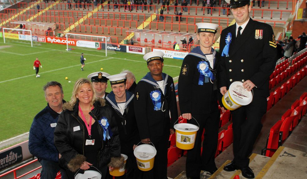Jeff Merrett and Tina Kingdom of Dream-A-Way joined by members of HMS Defender’s ships company about to start the bucket collection