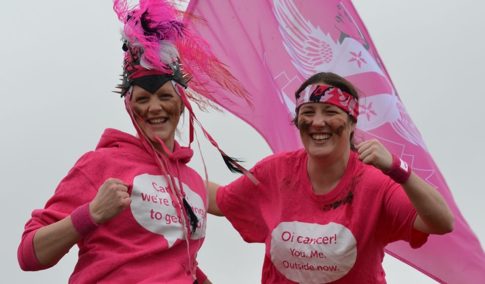 Ruth Chamings (left) and Maxine Bateman, Exeter charity workers donned in muddy war paint, battle headdress and flying the flag for Race for Life.