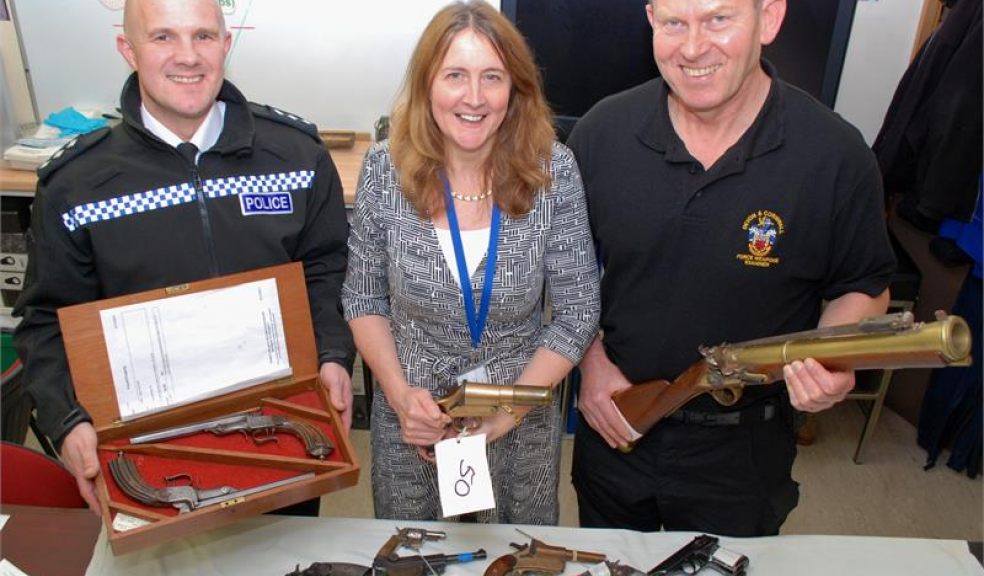 Chief Inspector Daniel Evans with antique duelling pistols, Firearms and Explosives Licensing Manager Michelle Mounsey with WW1 flare pistol, Armourer Mike Barker with replica blunderbuss
