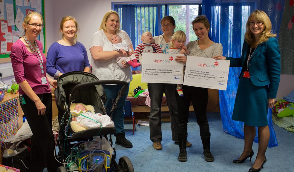 Jayne Carroll, Head of Integrated Children's Services, pictured far right, presents cheques to Tristan's mum Charlie Palmer, alongside fellow fundraising mums