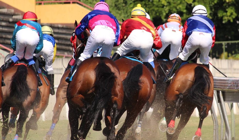 jockeys racing horses