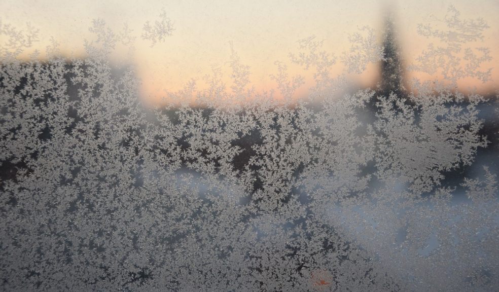 A window with ice crystals and frost on it