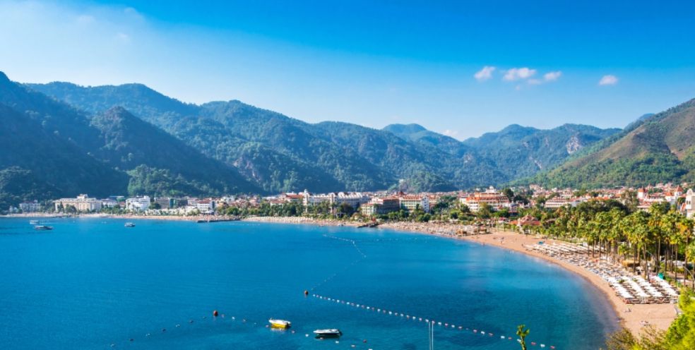 Icmeler bay showing beach and mountains and resort in middle