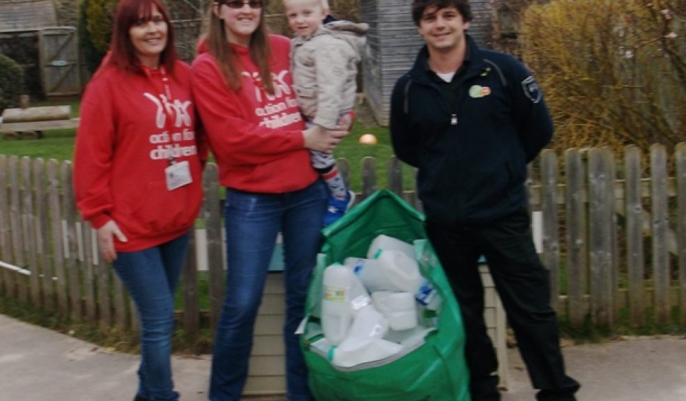 Pictured with the first of 14 bags of plastic four-pint containers delivered to Whipton Children's Centre are (left to right) Sue Skinner, Leanne Cooper (holding Charlie) and James Gatter, SITA UK's East Devon Contract Supervisor.