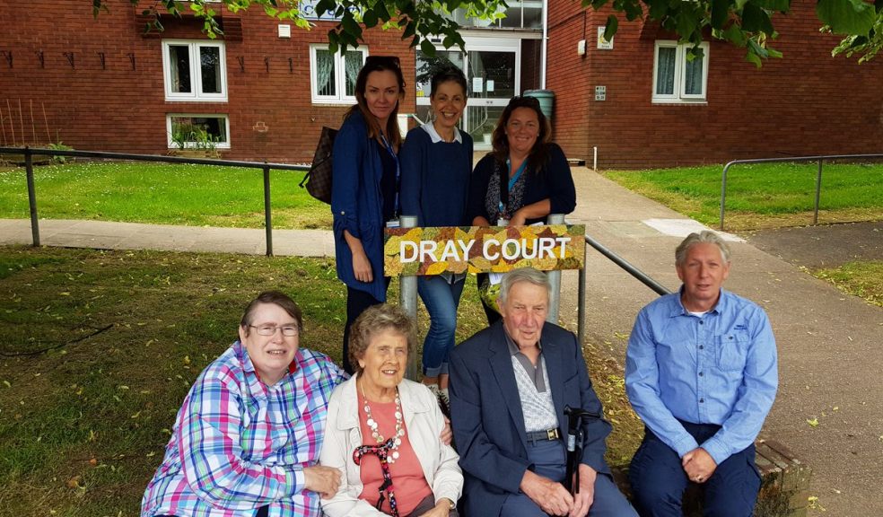 Councillor Jill Elson, EDDC mobile support officers, tenants David Scott and Pat Crocker and artists Allan Punton and Manya McMahon with the Dray Court signs.
