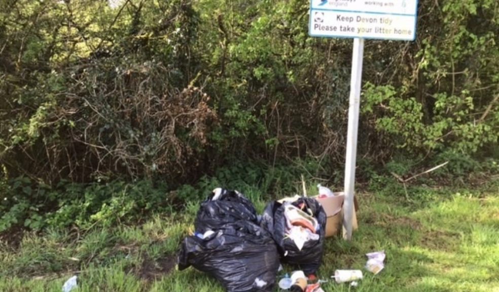 Caption: Litter left in an A30 layby near Okehampton, at the foot of a Highways England ‘Keep Devon tidy’ sign