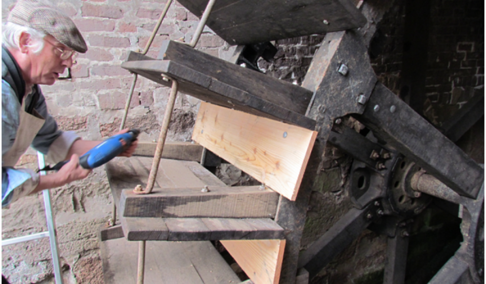 Volunteer millers attach the sole boards
