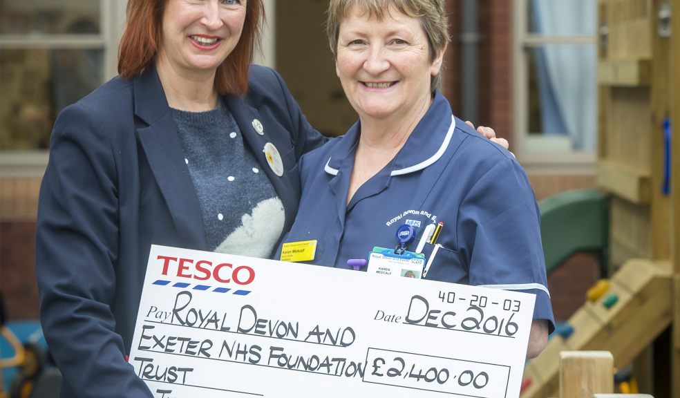 Jo Evans, Tesco community champion and Karen Medcalf - senior nurse for Paediatrics with the cheque. Photo by Guy Harrop.