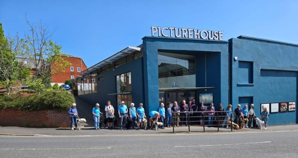 A group of volunteers with their guide dog pups in training stand in front of the Exeter Picturehouse A group of volunteers with their guide dog pups in training stand in front of the Exeter Picturehous