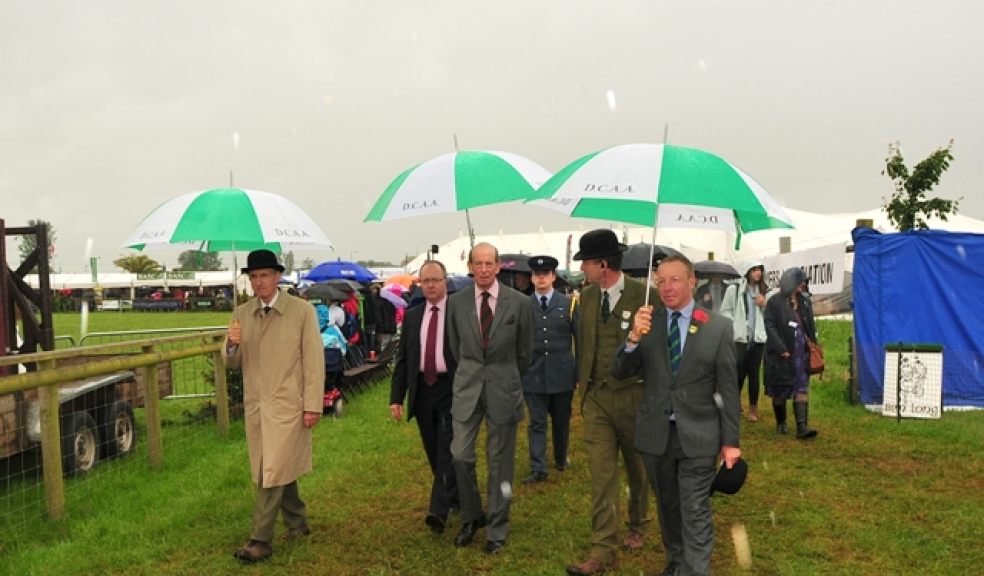 Photo: Royals visit the show in wet weather Credit: Steve Pope