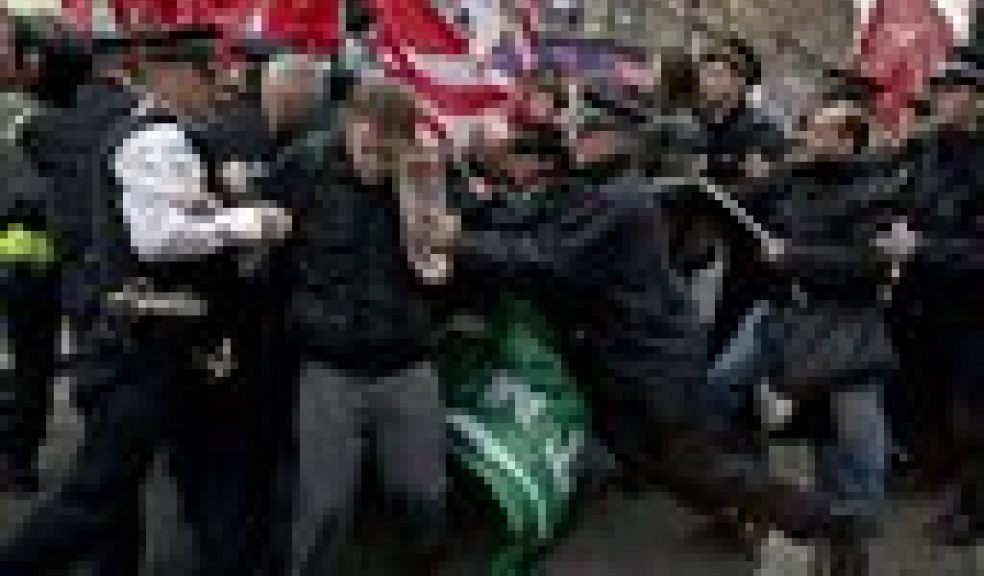Police officers try to push protesters back onto the pavement after they blocked traffic on Oxford Street, London, whilst taking part in a picket and demonstration they said was over dismissals of 28 workers employed by contractors on the Crossrail transport project, for being trade union members, Wednesday, Nov. 14, 2012. The protest was held to coincide with planned European strikes on Wednesday in Spain, Italy, Greece, Portugal, France and Belgium against austerity measures and economic reforms. Crossrail, due to start running services in 2018, is a new train line that will include twin-bore 21 km tunnels under central London and link 37 stations including transport hubs such as Heathrow airport with business districts including the City and Canary Wharf. (AP Photo/Matt Dunham)