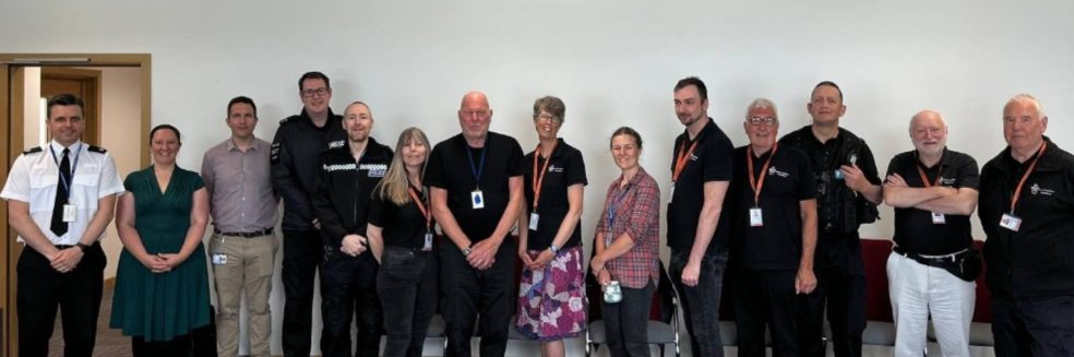 Photo caption: volunteers at Exeter police station with Supt Antony Hart (far left).