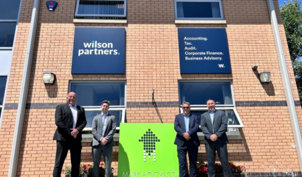 Four Wilson partners stood outside building