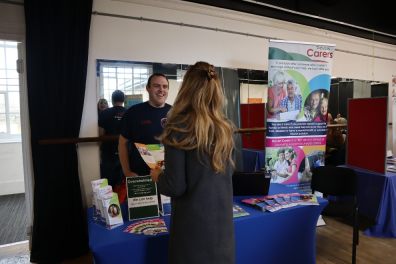 Andy Hood with a carer on the Devon Carers stand. Photo by Devon Carers.