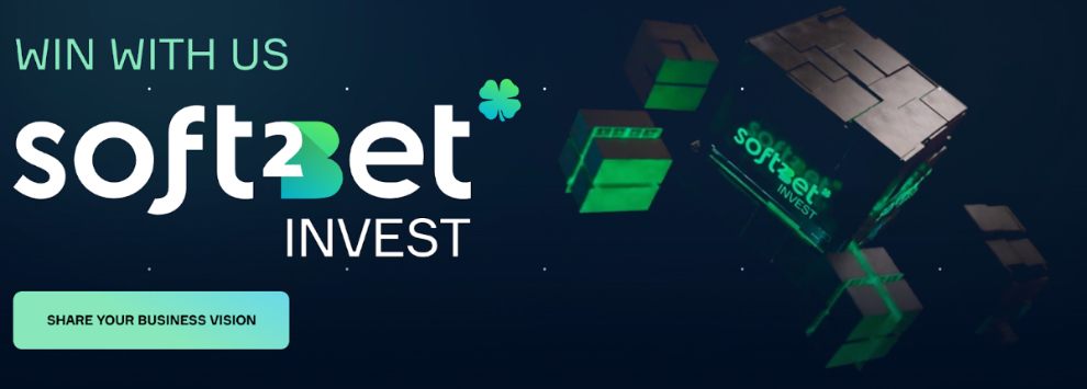 Soft2Bet Invest promotional banner with slogan “Win With Us” and a call-to-action button saying “Share Your Business Vision”