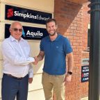 Two professionals shaking hands after business acquisition