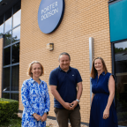 Three people stood outside a Porter Dodson office
