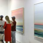 People talking at an art exhibition