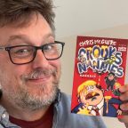 Chris McGuire holding his book