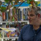 James stood in front of library books