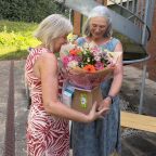 Kay receiving flowers from Mary Jane Campbell