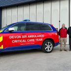 Picture of 4 men standing next to a Devon Air Ambulance critical care car
