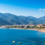 Icmeler bay showing beach and mountains and resort in middle
