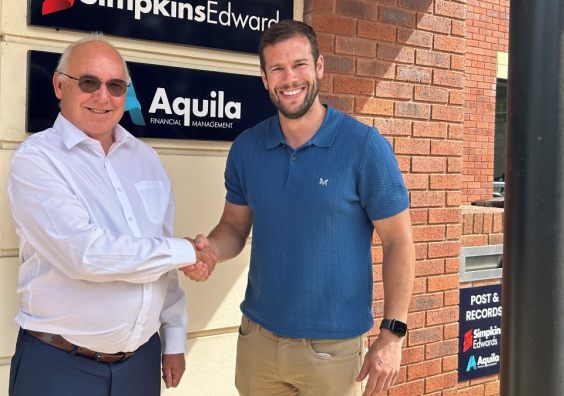 Two professionals shaking hands after business acquisition