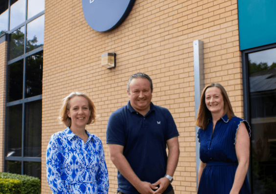 Three people stood outside a Porter Dodson office