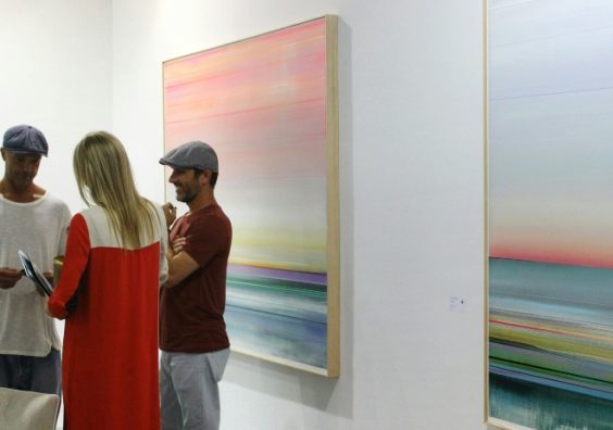 People talking at an art exhibition