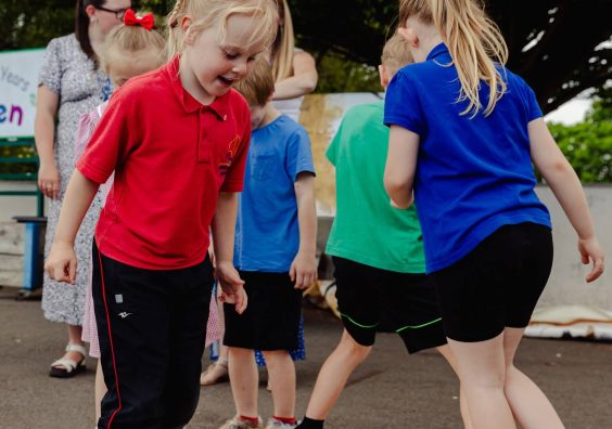Children doing group art project with their feet