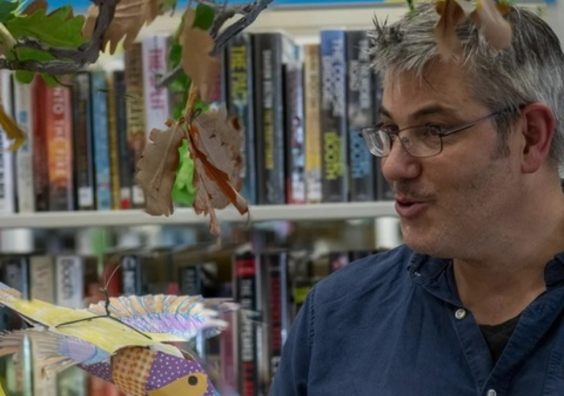 James stood in front of library books