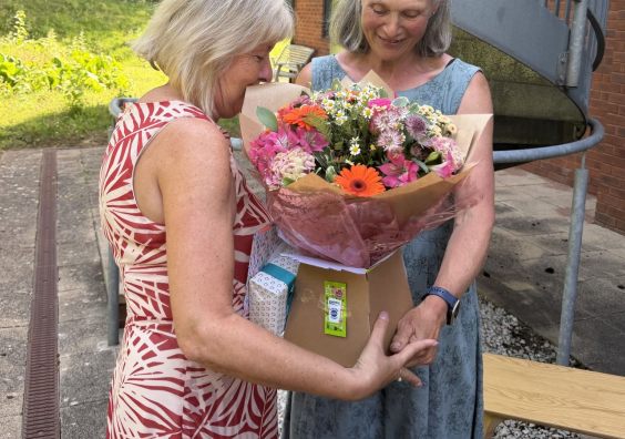 Kay receiving flowers from Mary Jane Campbell Kay receiving flowers from Mary Jane Campbell