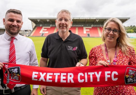 Pictured are, L-R, Tom Wenborn (ECFC) with Duncan Worthington and Hannah Barnard from Taking Care.