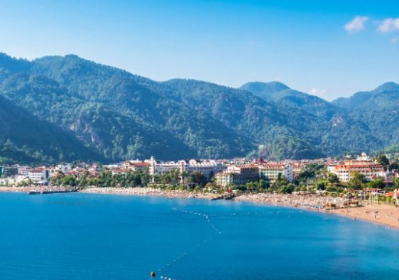 Icmeler bay showing beach and mountains and resort in middle