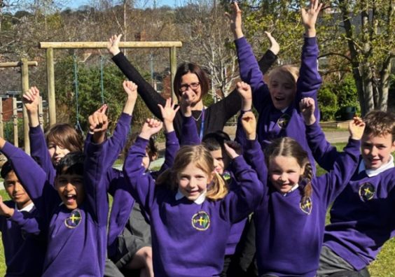 happy pupils in purple uniform celebrating St Sidwells School Exeter ousted report