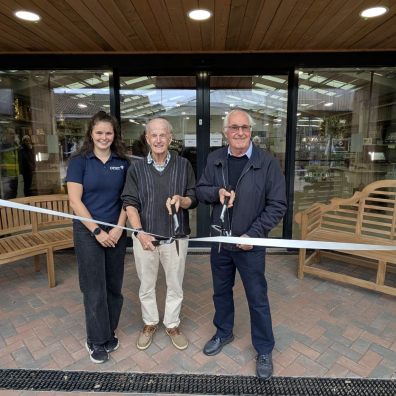 Lara White, Malcolm White and Bob Joy cutting the ribbon Three people cutting the ribbon on a new entrance to Otter Garden Centres in Ottery St Mary