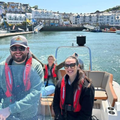 A family on a power boat leaving harbour