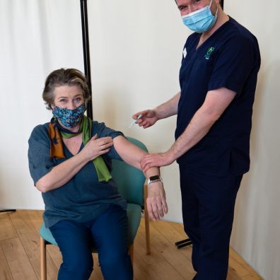 Dr Jon Williams of Amicus Health gives Caroline Quentin her vaccine