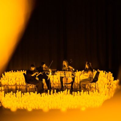 An orchestra playing in candlelight