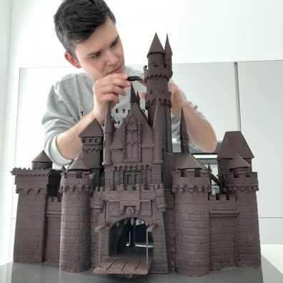 Kieran Charles putting the finishing touches to his chocolate castle