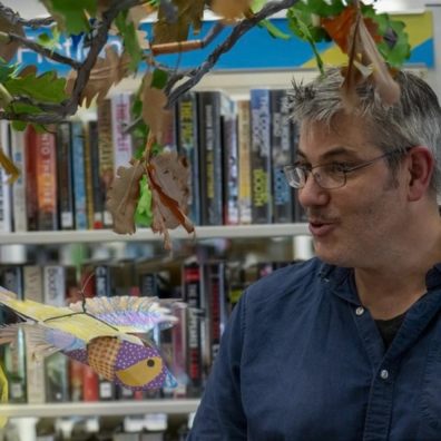 James stood in front of library books