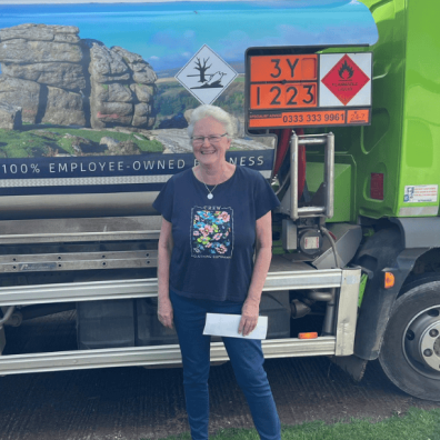 Woman stood in front of Moorland Fuels Tanker