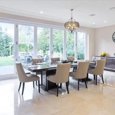 A living room filled with furniture and a large bi fold door