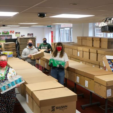 Staff from Exeter City Community Trust and volunteers pack up parcels at St James Park