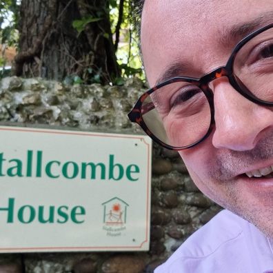 Man in front of sign for Stallcombe House