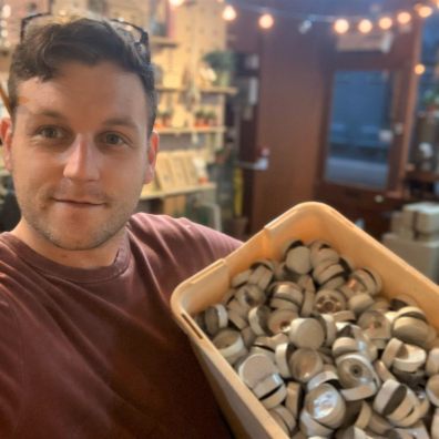 Man holding box of tealights