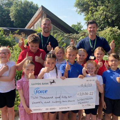 Wynstream School children present a cheque to FORCE Cancer Charity