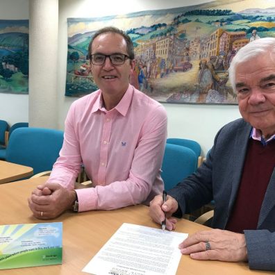 Teignbridge's Managing Director Phil Shears, left, and Council Leader Cllr Gordon Hook sign the Devon Climate Declaration 