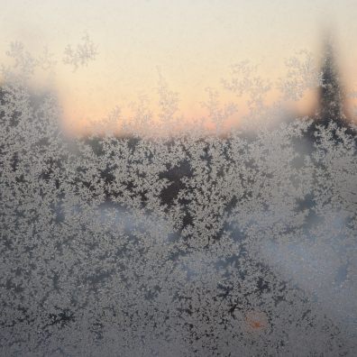 A window with ice crystals and frost on it